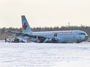 Crews work on the Airbus A320 that was flown as Air Canada Flight 624 which slid off a runway at the end of Halifax Stanfield Airport in Enfield, Nova Scotia, March 29, 2015.  The Air Canada plane slid off a runway and suffered heavy damage while landing in the east coast city of Halifax on Sunday, sending more than 20 passengers and crew to hospital with non-life threatening injuries. The incident happened shortly after midnight. The airline said in an update on Sunday afternoon that all but one of those admitted to hospitals had now been released.  REUTERS/Mark Blinch