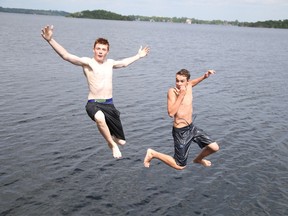 Michael Andlar and Dakota Coggins cool off in Ramsey Lake in Sudbury, Ont. on Monday June 15, 2015. The forecast for Tuesday calls for a mix of sun and cloud and a high in the low 20's. Gino Donato/Sudbury Star/Postmedia Network