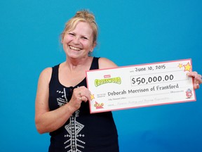 SUBMITTED PHOTO
Debora Morrison, of Frankford, accepts her $50,000 winnings at the OLG Prize Centre in Toronto.