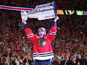 Winnipeg's Jonathan Toews, captain of the Chicago Blackhawks, hoists the Stanley Cup for the third time Monday night at the United Center. Toews is already in elite company in terms of Cups won by NHL captains. (Dennis Wierzbicki/USA TODAY Sports)