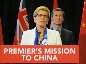 Premier Kathleen Wynne and Michael Chan are pictured during an announcement of a China trade mission in this October 2014 file photo. (ANTONELLA ARTUSO/Toronto Sun)