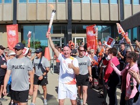 Wes Harding leads the Toronto 2015 Pan Am and Parapan Am Games torch relay from city hall on Tuesday June 16, 2015 in Sarnia, Ont. (Terry Bridge/Sarnia Observer/Postmedia Network)