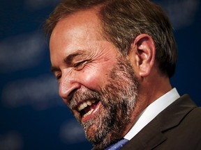NDP leader Thomas Mulcair smiles during a speech to the economic community during a business luncheon in Toronto, June 16, 2015. (MARK BLINCH/Reuters)