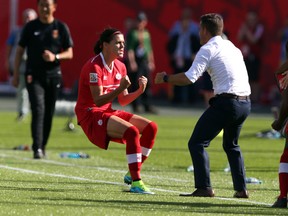 Canada's captain Christine Sinclair gets ready to hug head coach John Herdman after scoring on a penalty shot against China during the opening game of the Women's World Cup in Edmonton on Saturday, June 6, 2015. (Perry Mah/Postmedia Network)