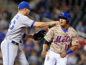 Toronto Blue Jays second baseman Danny Valencia tags out New York Mets third baseman Ruben Tejada during the 11th inning of an interleague game at Citi Field in New York on June 15, 2015. (BRAD PENNER/USA TODAY Sports)
