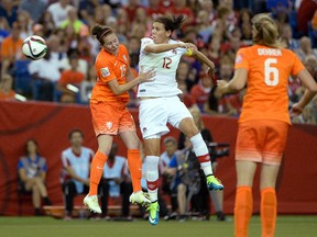 Netherlands defender Merel Van Dongen (15) and Canada forward Christine Sinclair (12) battle for a header during the second half in a Group A soccer match in the 2015 FIFA women's World Cup at Olympic Stadium. (Eric Bolte-USA TODAY Sports)