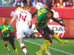 Canada’s Samuel Piette goes up for a header against two Dominica players during Tuesday night’s game at BMO Field. (MICHAEL PEAKE/Toronto Sun)