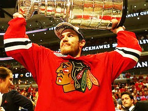Belleville's Andrew Shaw hoists the Stanley Cup Monday night in Chicago where the Blackhawks clinched the NHL playoff title with a 2-0 win over Tampa Bay. (Getty Images)