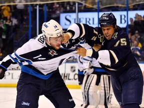 Anthony Peluso, seen here tussling with Ryan Reaves of the St. Louis Blues, has signed a new two-year deal to stay with the Jets. (Jasen Vinlove-USA TODAY Sports file photo)