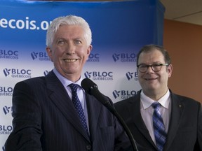 Gilles Duceppe (L) and Mario Beaulieu smile during a news conference to announce Duceppe's return to federal politics as leader of the Bloc Quebecois, in Montreal June 10, 2015.  REUTERS/Christinne Muschi