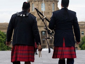 Members of the Toronto Police Pipe Band walk to the start of the funeral procession for Const. Daniel Woodall at the Alberta Legislature, in Edmonton Alta. on Wednesday June 17, 2015. Woodall was killed in the line of duty June 8, 2015. David Bloom/Edmonton Sun