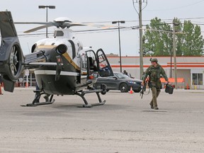 Ontario Provincial Police TRU team officers arrived in Timmins to assist with the Canadian Tire armed standoff situation. 
Timmins Times LOCAL NEWS photo by Len Gillis.
