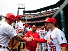 Cardinals second baseman Kolten Wong (16) is congratulated by shortstop Pete Kozma (38) and centre fielder Jon Jay (19) after scoring against the Twins at Busch Stadium in St. Louis on Tuesday, June 16, 2015. (Jeff Curry/USA TODAY Sports)