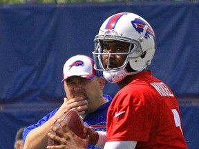 Buffalo Bills quarterback E.J. Manuel sets to throw a pass as offensive coordinator Greg Roman watches during Day 2 of the team's mandatory mini-camp practice on Wednesday, June 17, 2015 in Orchard Park, N.Y. (John Kryk/Postmedia Network)