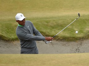 Tiger Woods hits out of the bunker on the fifth green during practice rounds at Chambers Bay in University Place, Wash., on Tuesday, June 16, 2015. (John David Mercer/USA TODAY Sports)