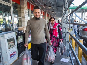 Mohmed Bilal and his wife Rabiya Kazi have their hands full with groceries from Iqbal Halal Foods in preparation for Ramadan in Toronto on Wednesday June 17, 2015. (Ernest Doroszuk/Toronto Sun)