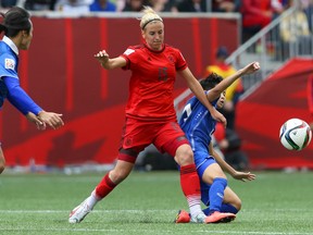 German defender Jennifer Cramer, centre, battles forwards from Thailand during a Group B soccer match at the 2015 FIFA women's World Cup in Winnipeg. Top-ranked Germany will face fifth-ranked Sweden in the Round of 16 in Ottawa on Saturday. (Bruce Fedyck-USA TODAY Sports)
