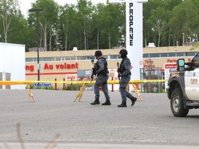 Timmins Police emergency response team officers patrolled the Canadian Tire plaza parking lot for most of Wednesday. As it turned out, the break-in suspect was not in the store. (Len Gillis/Timmins Times/Postmedia Network)