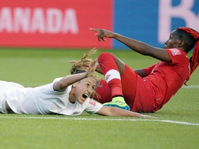 New Zealand midfielder Annalie Longo (16) reacts after she is brought down by Canada defender Kadeisha Buchanan (3) during the second half in a Group A soccer match in the 2015 FIFA women's World Cup at Commonwealth Stadium. (Erich Schlegel-USA TODAY Sports)