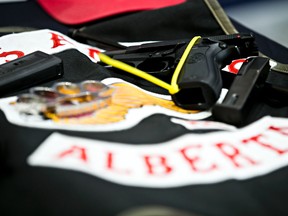 Police show off items confiscated during 10 search warrants that were executed at Alberta Hells Angels clubhouses in Edmonton, Alta., in this April 25, 2014 file photo. (Codie McLachlan/Postmedia Network)