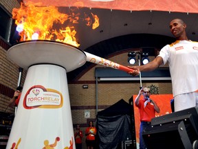 Athlete Damian Warner lights the Pan Am Games cauldron at an event in London Ont.’s Victoria Park June 17, 2015. CHRIS MONTANINI\LONDONER\POSTMEDIA NETWORK
