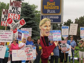 Labour and anti-wind turbine protesters greet Ontario Premier Kathleen Wynne who was speaking at a Sarnia-Lambton Chamber of Commerce luncheon on Thursday June 18, 2015 at the Guildwood Inn in Point Edward, Ont. (Paul Morden, The Observer)
