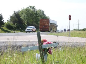 JASON MILLER/THE INTELLIGENCER
Vehicles drive along Highway 37 at the Wiser Road intersection, metres north of where a 55-year-old man was killed in a collision Wednesday night. Though not linked to the cause of Wednesday nights crash, the Wiser Road and Highway 37 stretch isn't new to fatalities as it is where two women were killed when their vehicle was rear-ended by a tractor trailer in Dec. 2011. Pictured here is a cross planted in memory of the women.