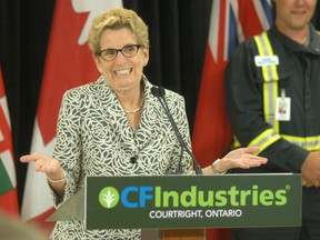 Ontario Premier Kathleen Wynne shrugs her shoulders in response to a question at a press conference Thursday at the CF Industries' nitrogen complex located near Courtright, Ontario. CF Industries announced that they are undergoing a $105-million expansion.
PHOTO TAKEN Thursday, June 19, 2015 near Sarnia, Ontario.
(DAVID GOUGH/ WALLACEBURG COURIER PRESS/ POSTMEDIA NETWORK)