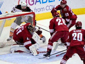 Coyotes goalie Mike Smith makes a save on Ducks centre Nate Thompson (44) as defencemen Michael Stone (26) and Oliver Ekman-Larsson (23), and left wing Tye McGinn (20) defend during NHL action at Gila River Arena in Glendale, Ariz., on March 3, 2015. (Matt Kartozian/USA TODAY Sports)
