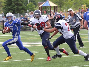 Nicholas Rideout, left, of the Sudbury Junior Gladiators, evades a pursuit by Vaughan Rebels defenders during football action at James Jerome Sports Complex last Saturday. Both Gladiators teams are at home this weekend when they host the Toronto Jr. Argos.