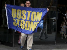 Boston Marathon bombing witness Carlos Arredondo (L) and bombing survivor Karen Brassard (R) walk out of the federal courthouse.

REUTERS/Brian Snyder
