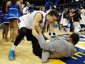 Georgia State’s R.J. Hunter celebrates with his father, head coach Ron Hunter, after defeating the Georgia Southern Eagles to win the Sun Belt Conference during NCAA March Madness action. Hunter is projected to go in the first round of the NBA draft. (AFP/PHOTO)