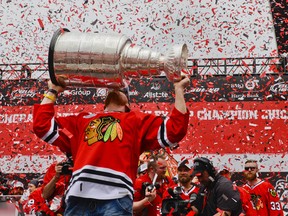 Marian Hossa hoists the Stanley Cup at the Blackhawks' Championship rally. (USA Today Sports)