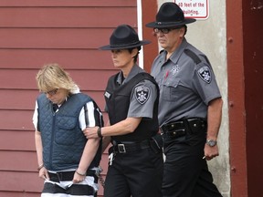 Joyce Mitchell is escorted out of the courtroom after appearing before a judge in Plattsburgh City Court, New York  on June 15.  Mitchell is accused of helping convicted killers Richard Matt and David Sweat escape from Clinton Correctional Facility in Dannemora, New York on June 6. (REUTERS/G.N. Miller)