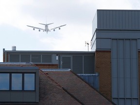 A 747 flies over the headquarters of online retailer NotOnTheHighStreet.com as it approaches Heathrow airport over Richmond in west London, June 19, 2015.  British police were investigating whether a body found on the roof the online retailer in southwest London was that of a stowaway who had fallen from the undercarriage of a plane as it came in to land from South Africa. REUTERS/Suzanne Plunkett