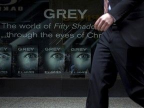 A man passes by an advertisement for 'Grey' outside a bookstore in New York June 18, 2015. Fans of British author E.L. James' "Fifty Shades of Grey" erotic trilogy clamored on Thursday to get the first copies of her new book "Grey," a version of the first novel told through the eyes of her famous male character.  REUTERS/Brendan McDermid