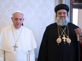 This handout picture released by the Vatican press office, Osservatore Romano, shows Pope Francis (L) receiving Syriac Orthodox Patriarch of Antioch and all of the East Moran Mor Ignatius Aphrem II  on June 19, 2015 at the Vatican. AFP PHOTO / OSSERVATORE ROMANORESTRICTED TO EDITORIAL USE - MANDATORY CREDIT