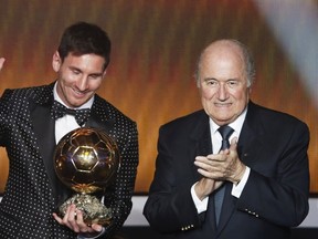 FIFA President Sepp Blatter applauds as Lionel Messi of Argentina receives the FIFA Men's World Player of the Year award during the FIFA Ballon d'Or 2012 gala at the Kongresshaus in Zurich, in this January 7, 2013 file photo. (REUTERS/Michael Buholzer/Files)