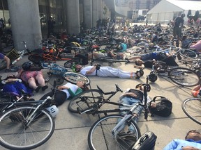 Cyclists stage a die-in at City Hall on Friday, June 19, 2015. (DON PEAT/Toronto Sun)