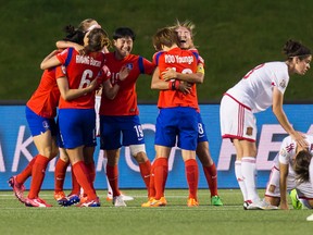 Players from Korea Republic celebrate their 2-1 victory over Spain following action at the FIFA Women's World Cup Canada 2015 at Lansdowne Stadium in Ottawa on June 17, 2015. Errol McGihon/Ottawa Sun/Postmedia Network