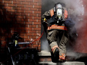 EMILY MOUNTNEY-LESSARD/THE INTELLIGENCER
A firefighter enters a building filled with simulated smoke during Firefighter Survival Training on Friday in Belleville.