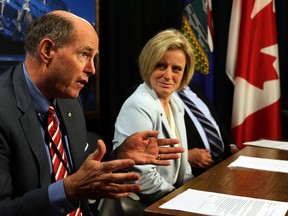 David Dodge, former Governor of the Bank of Canada (l) and Premier Rachel Notley (R) speak on the development of a new infrastructure plan during a news conference at the Alberta Legislature on Thursday, June 19, 2015. Perry Mah/Edmonton Sun/Postmedia Network