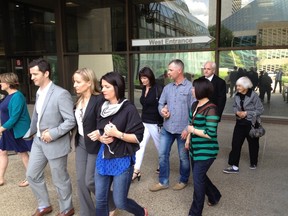 Family of murder victim Dale Maloney leaving Edmonton's Law Courts building Friday after reading out their victim impact statements at the second-degree murder sentencing of Christian Iyamuremye.