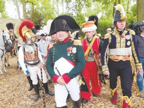 French lawyer Franck Samson, centre, dressed as Napoleon Bonaparte, walks with his entourage during commemorations marking the 200th anniversary of the Battle of Waterloo in Waterloo, Belgium, on Thursday. (Emmanuel Dunand/AFP photo)