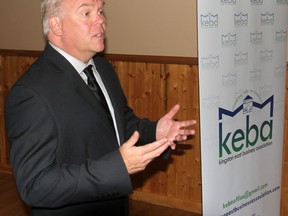 Derek Baylis, president of the Kingston East Business Association, stands in front of their new logo during a membership drive meeting at the Glen Lawrence Golf Club in Kingston, Ont. on Fri., June 19, 2015. Michael Lea/The Whig-Standard/Postmedia Network