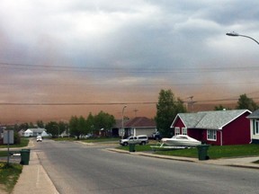 Dust from the Wabush mine hangs in the air in Wabush, N.L., in this photo taken in July 2013. (NATALIE LACY/Reuters)