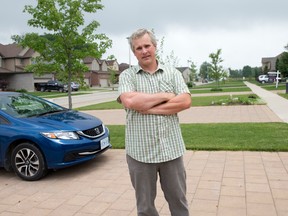 Londoner Sean Quin stands on the boulevard in front of his Wickerson Road home, where neighbourhood residents have started getting tickets for parking vehicles and boats. (CRAIG GLOVER, The London Free Press)