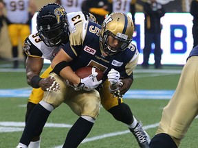 Drew Willy gets sacked during Friday night's tilt against the Ticats. (KEVIN KING/Winnipeg Sun)