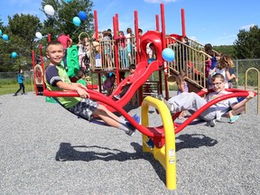 Nathan Horner, 8, left, and Kieran Joncas, 10, play on a new play structure at R. H. Murray Public School in Whitefish, Ont. on Friday June 19, 2015. A ceremony was held at the school to show off the new play structure and outdoor classroom. John Lappa/Sudbury Star/Postmedia Network
