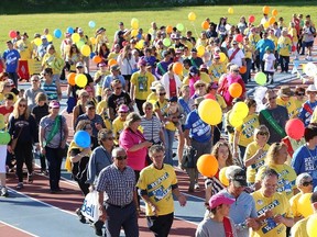 John Lappa/The Sudbury Star

Participants take part in the survivors' victory lap at the Canadian Cancer Society's Relay for Life at the track at Laurentian University on Friday evening. Money raised from the event goes to cancer research and community support services.